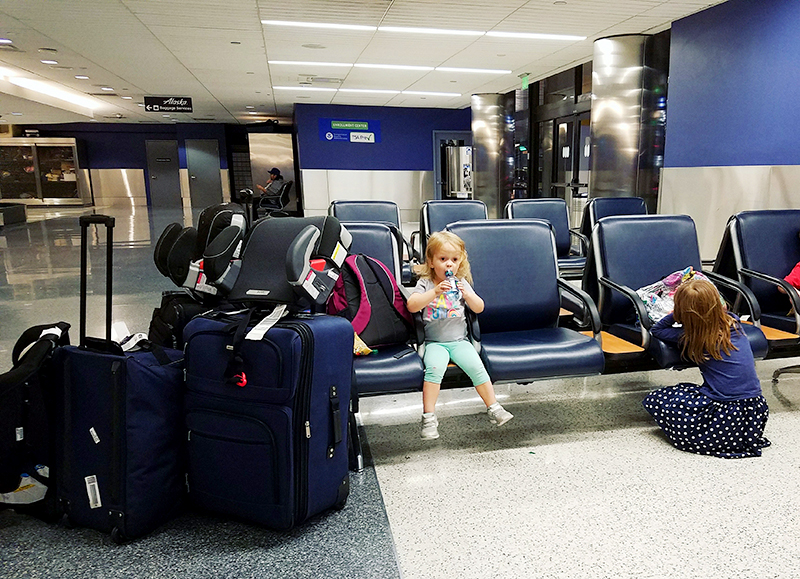 Little girl drinking water in an airport.