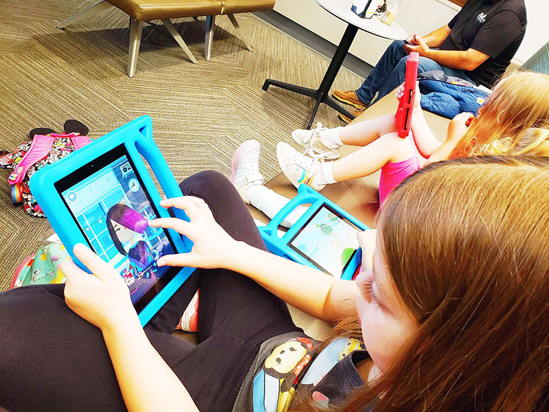 My kids playing with Kindle Fire tablets at the airport