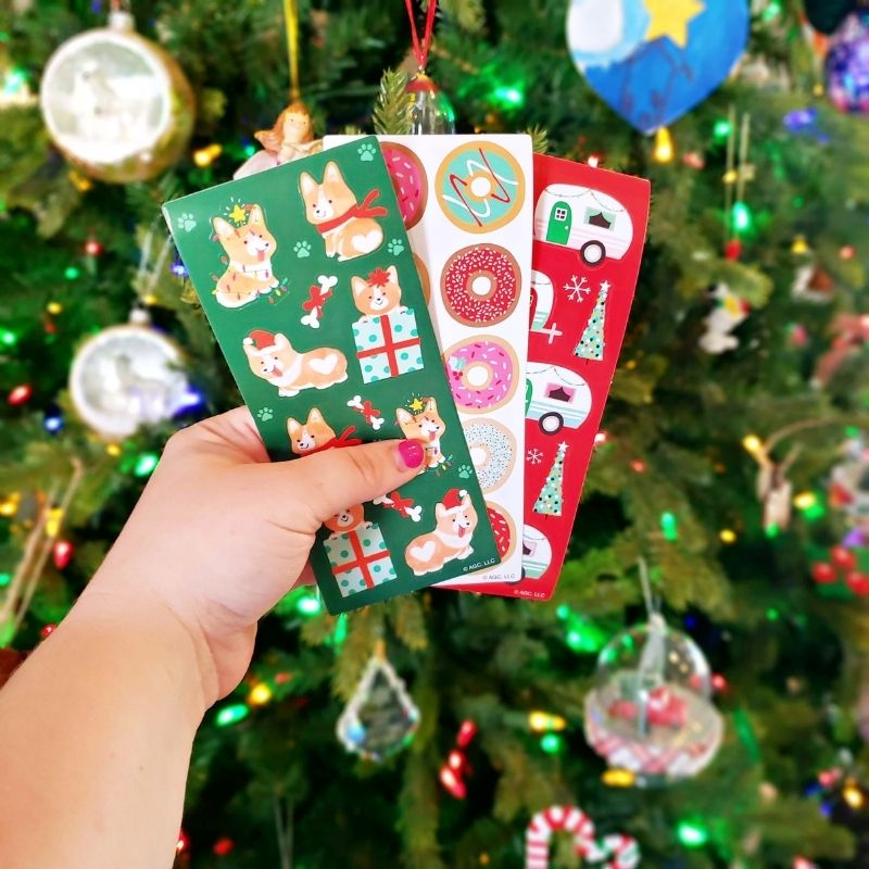 Hand holding Christmas stickers